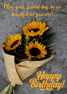 a bouquet of sunflowers is sitting on the ground with a happy birthday message