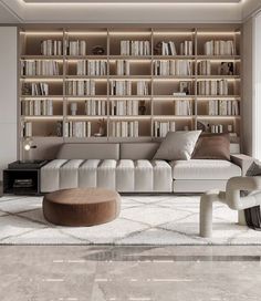 a living room filled with lots of white furniture and bookshelves on the wall