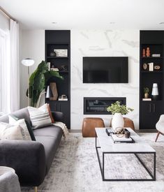 a living room filled with furniture and a flat screen tv mounted on the wall above a fireplace