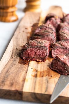 steak on a cutting board with a knife