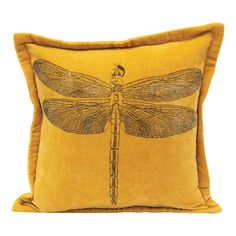 a yellow pillow with a dragonfly on it