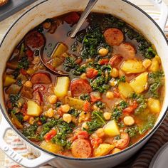 a pot filled with stew and vegetables on top of a table