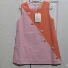 Tbbc Girls Corduroy Orange Pink Sleeveless Dress. It Has 6 Decorative Buttons Down The Front And Is Half Orange And Half Pink. Super Cute And Brand New With Tags. It Is A Size 6 And Has 3 Buttons On The Top Back For Easy Changing. Fully Lined And Comes With 2 Extra Buttons. Cute Pink Fitted Sleeveless Dress, Pink Fitted Sleeveless Cute Dress, Cute Fitted Pink Sleeveless Dress, Cute Pink Sleeveless Pinafore Dress, Cute Sleeveless Pink Pinafore Dress, Cute Pink Pinafore Dress For Spring, Pink Sleeveless Buttoned Dress, Casual Pink Sleeveless Cotton Dress, Cute Cotton Sleeveless Pinafore Dress