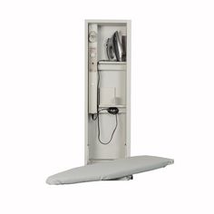 a white cabinet with an ironing board attached to the wall and power strip connected to it