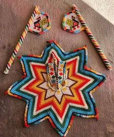 a multicolored crocheted star ornament next to two other items