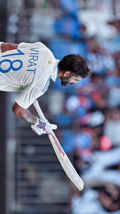 a man jumping in the air while holding a cricket bat