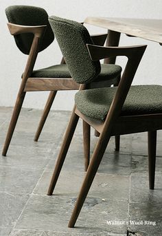 three chairs sitting next to each other near a table