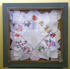 a shadow box is filled with vintage handkerchiefs