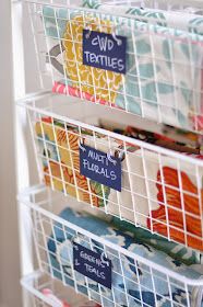 three baskets filled with fabric and labels on them