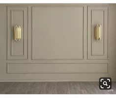 an empty room with white walls and gold accents on the doors is pictured in this image