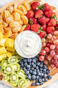 fruit platter with yogurt dip surrounded by fresh fruits