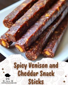 spicy venison and cheddar snack sticks on a white plate with text overlay