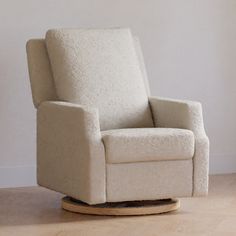 a white rocking chair sitting on top of a hard wood floor