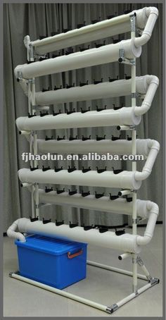 a large pipe rack with several pipes on it and a blue box in the foreground