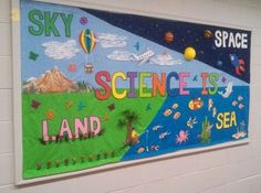 a bulletin board with the words science is land and space on it in front of a white wall