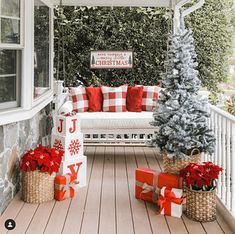 a porch decorated for christmas with red and white decorations