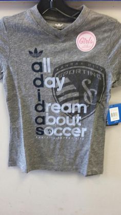 a t - shirt that says adidas day dream about soccer is hanging on a wall