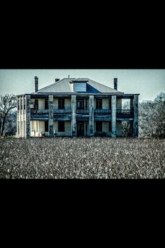 an old house in the middle of a field