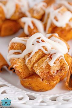 cinnamon rolls with icing on a white plate