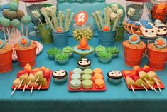 a table topped with lots of cupcakes and cakes