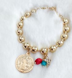 "18k Gold filled St Benedict medal bracelet MATERIAL AND SIZE: 18k Gold filled chain bracelet 18k Gold Filled St Benedict medal Cubic zirconia cross Coral and turquoise beads Medal size: 2 cm Size: 6.5\" + 1.5\" extender If you have questions about the product, feel free to reach me out. Don't forget to check out my other items in the store: Https://www.etsy.com/shop/nyahwithlove" Gold Spiritual Rosary Bracelet With Miraculous Medal, Gold Spiritual Rosary Bracelet With Charms, Spiritual Gold Rosary Bracelet With Charms, Miraculous Medal Bracelet Jewelry Gift, Gold Bracelets With Round Beads For First Communion, Spiritual Gold Rosary Bracelet For Blessing, Gold Spiritual Rosary Bracelet For First Communion, Spiritual Gold Rosary Bracelet For First Communion, St Benedict Medal