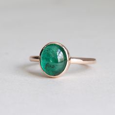 Metal: 14 Rose Gold Stone: Cabochon Emerald Stone Shape: Oval Stone Size: 9.5mm x 8mm Stone Weight: 2.7 carat Dimension: 2mm x 1.6mm band width Elegant Oval Rose Gold Emerald Ring, Elegant Rose Gold Oval Emerald Ring, Formal Oval Emerald Ring In Rose Gold, Formal Rose Gold Oval Emerald Ring, Classic Emerald Ring With Bezel Setting, Oval Cabochon, Rose Gold Oval Emerald Ring, Classic Oval Cabochon Ring With Smooth Bezel, Formal Rose Gold Oval Cabochon Ring, Elegant Emerald Ring With Oval Cabochon Bezel Setting