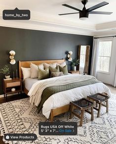 a bedroom with a bed, dresser and ceiling fan in the middle of the room