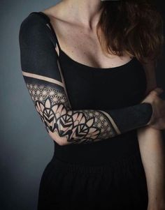 a woman with tattoos on her arm