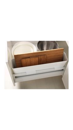 an open drawer with dishes and utensils in it