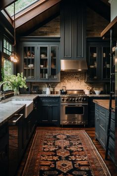 a kitchen with black cabinets and an area rug on the floor in front of the stove