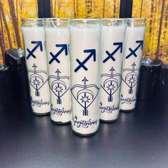 four white cups with blue arrows on them