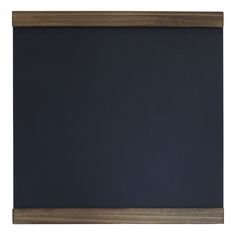 a wooden frame holds a chalkboard on the wall, and it is dark blue in color