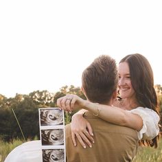 a man and woman hugging each other in front of a car with pictures on it