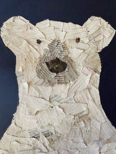 an animal made out of newspaper strips on a blue background with the image of a bear's head