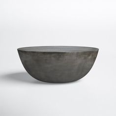 a gray bowl sitting on top of a white table