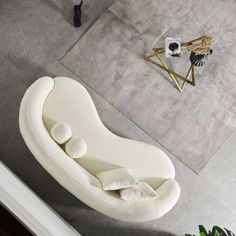 a white couch sitting on top of a living room floor