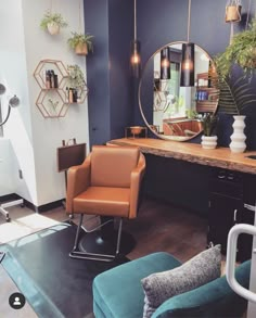 a chair and mirror in a room with blue walls