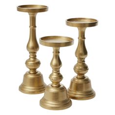 two brass candlesticks sitting next to each other