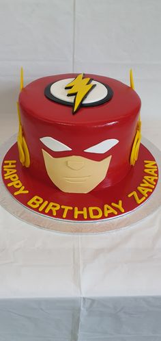 a birthday cake with the flash symbol on it