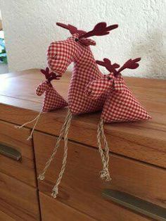 two paper animals sitting on top of a wooden dresser