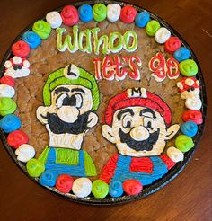 there is a cake that has been decorated to look like mario and luigi's go