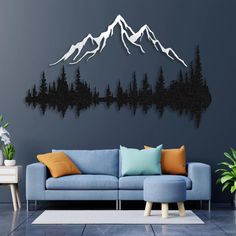 a living room with a blue couch and mountain scene on the wall