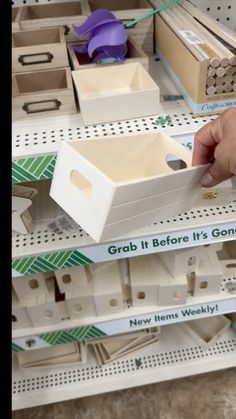 a person is picking up some items from a shelf in a store that's on sale