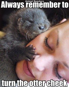 a woman is cuddling an animal with her eyes closed and it's head on top of another animal