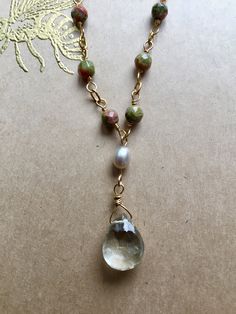 "A handmade chain of 12 faceted Unakite beads leads to a sparkling, faceted Green Amethyst drop hanging by a small Fresh Water Pearl. The closure features an additional Unakite bead. - 18\" long - gold-fill chain - Unakite, Pearl, and Green Amethyst - strong gold-fill clasp Arrives in a beautifully wrapped box with a gold-embossed bee design on the cover, a ribbon, and matching tissue paper." Handmade Chain, Bee Design, Fresh Water Pearl, Amethyst Necklace, Green Amethyst, Gold Filled Chain, Tissue Paper, Fresh Water, Freshwater Pearls