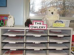 there is a book shelf with many books and stuffed animals on the shelves next to it