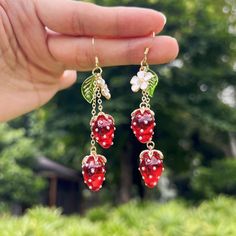 🙂Happy life and Sweet love are the symbolism of the strawberry.      Purity and peace are the meaning of the little white flower. These strawberry earrings bring sincere blessings whether for your own use or as a gift for the one you love. May these earrings brighten up your life. 🙂 All my jewellery is designed and made in my home. Handmade with love.   Small strawberry:  Length: 7.5 cm or 2.95 inches  Big strawberry: Length: 7cm or 2.76 inches 🙂Introducing our stunning handmade earrings, a pair of earrings made with dripping strawberries, small pearls and 925 anti-allergy silver hooks. The crystalline strawberries are red and sweet. The overall design is natural and unique, lovely and vibrant. The earrings are brightly coloured and striking for the unique you. Each pair of earrings is Apple Crochet, Mushroom Earring, Fruit Crochet, Mushroom Gifts, Cute Dangle Earrings, Strawberry Necklace, Strawberry Earrings, Fruit Necklace, Resin Earring