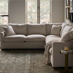 a living room scene with focus on the corner sofa and chair in the foreground