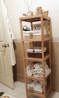 a wooden shelf filled with towels and other items