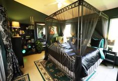 a canopy bed sitting in the middle of a bedroom